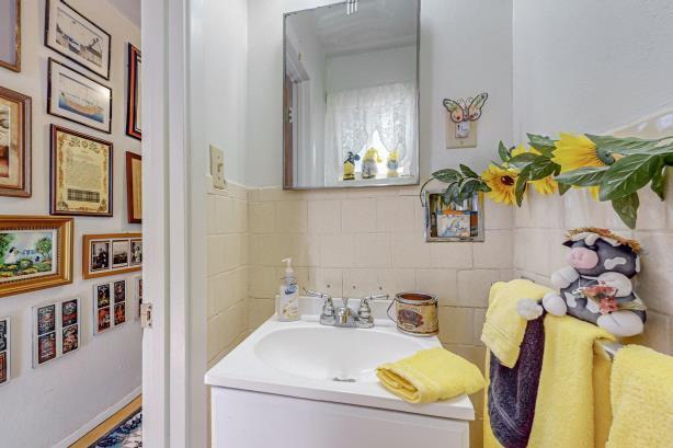 bathroom with vanity with extensive cabinet space and tile walls