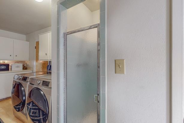 laundry room with cabinets, hardwood / wood-style floors, and washer and dryer