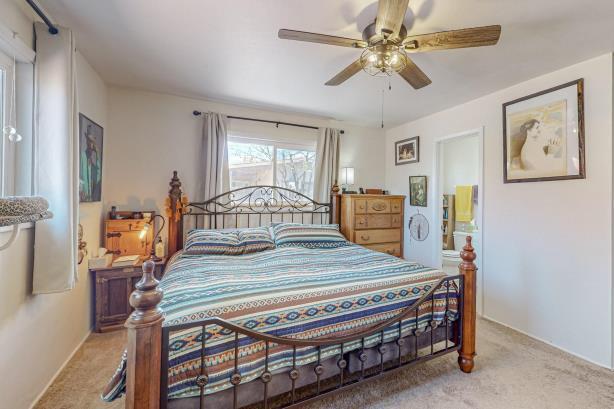 carpeted bedroom featuring ceiling fan