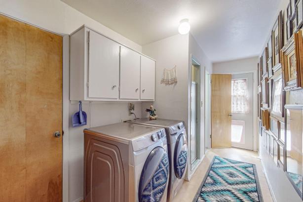 washroom featuring separate washer and dryer and cabinets