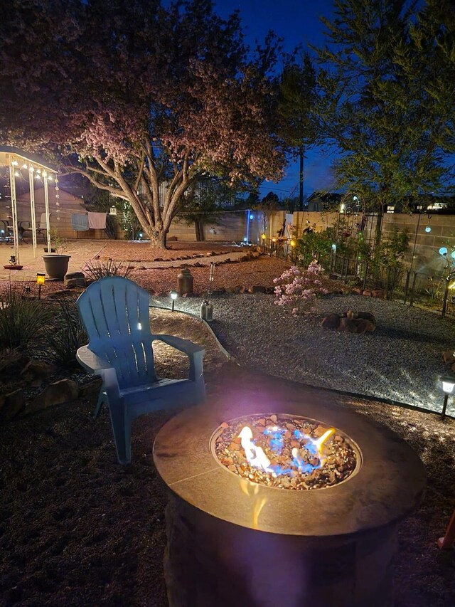 patio terrace at twilight featuring a fire pit