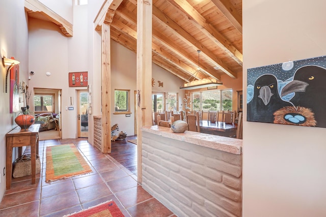 interior space with beamed ceiling, a wealth of natural light, and wooden ceiling