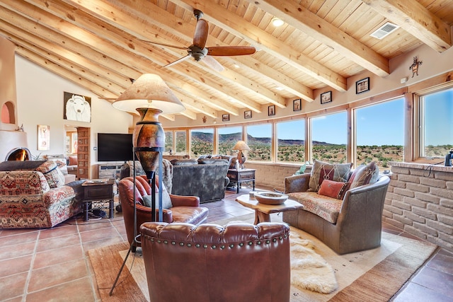 living room with ceiling fan, vaulted ceiling with beams, tile patterned floors, and wood ceiling