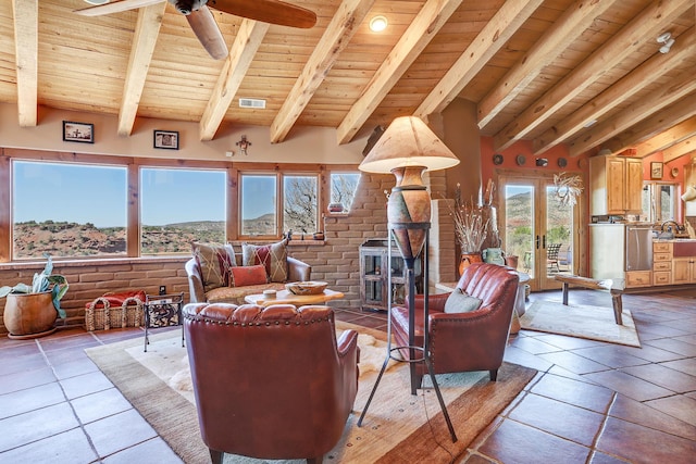 living room with vaulted ceiling with beams, ceiling fan, brick wall, and wooden ceiling