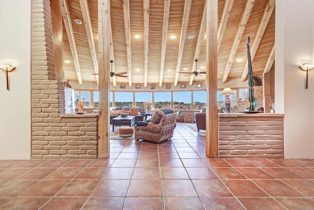 living room featuring wooden ceiling, ceiling fan, a towering ceiling, beam ceiling, and tile patterned flooring