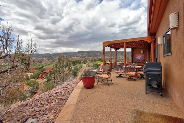 view of patio / terrace featuring a mountain view and a pergola