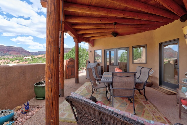 view of patio / terrace featuring french doors and a mountain view