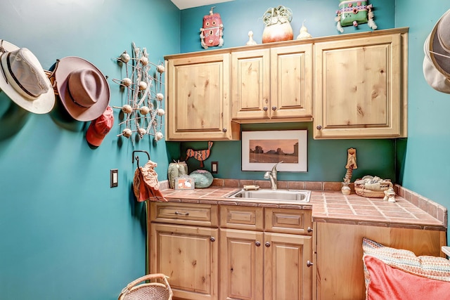 kitchen featuring sink, tile countertops, and light brown cabinets