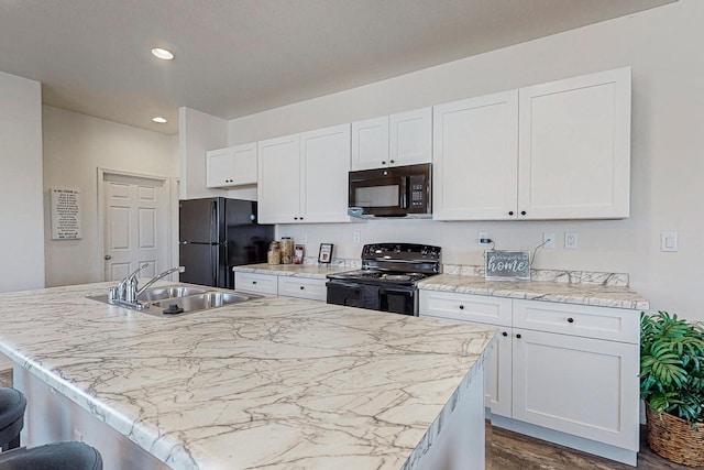 kitchen with a center island with sink, dark wood-type flooring, black appliances, and sink