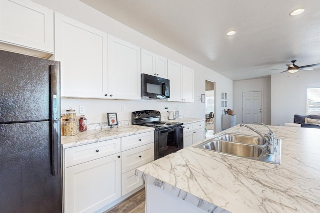 kitchen with sink, ceiling fan, white cabinetry, and black appliances