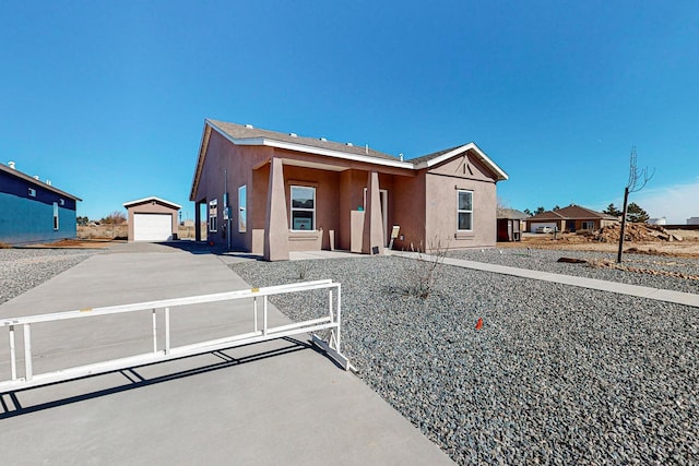 view of front of home featuring a garage and an outdoor structure