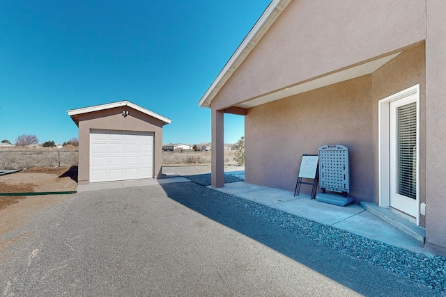 view of terrace featuring an outdoor structure and a garage