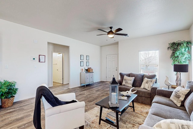 living room with hardwood / wood-style floors and ceiling fan