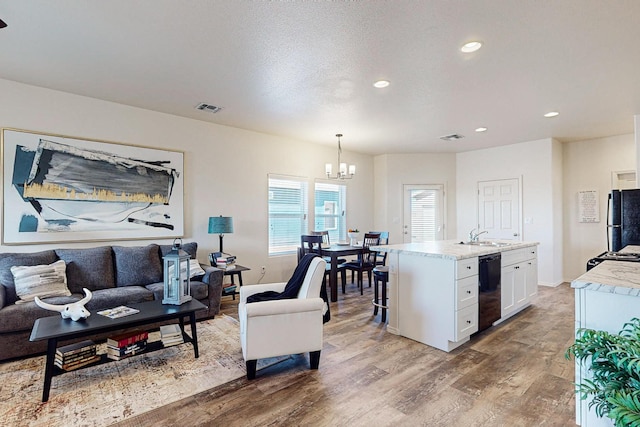 living room featuring hardwood / wood-style flooring and a chandelier