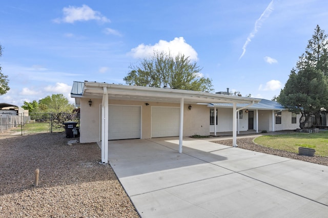 single story home featuring a garage, fence, driveway, stucco siding, and a front lawn