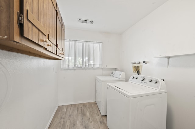 laundry area featuring visible vents, light wood-style floors, separate washer and dryer, laundry area, and baseboards