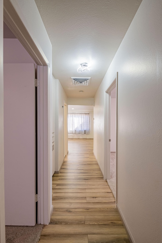 hall with light hardwood / wood-style floors