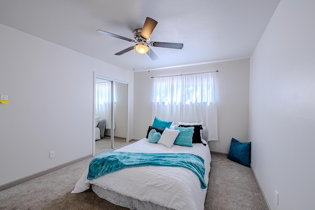 carpeted bedroom with a closet and ceiling fan