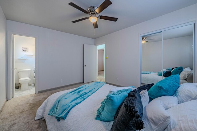 carpeted bedroom featuring ensuite bath, a closet, and ceiling fan