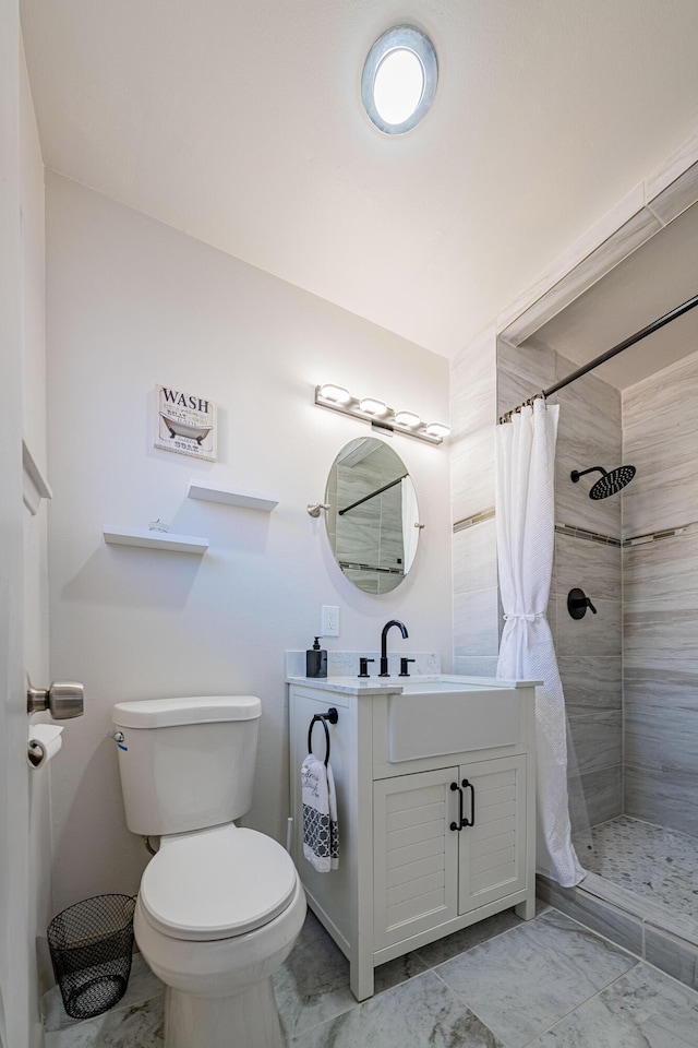 bathroom featuring vanity, curtained shower, and toilet