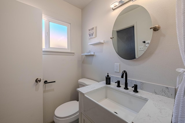 bathroom with vanity and toilet