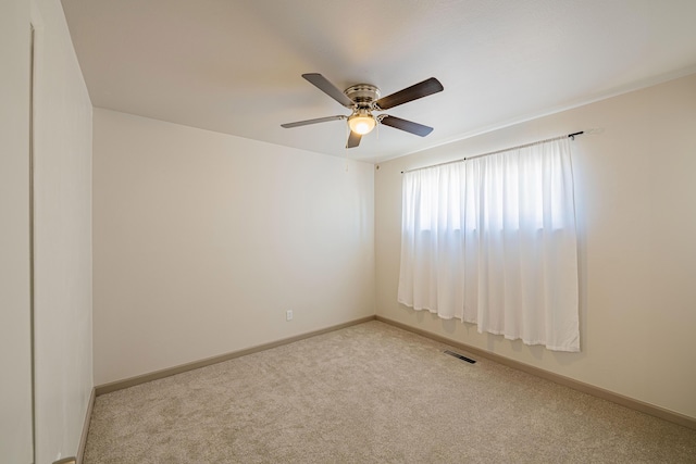 unfurnished room featuring light colored carpet and ceiling fan