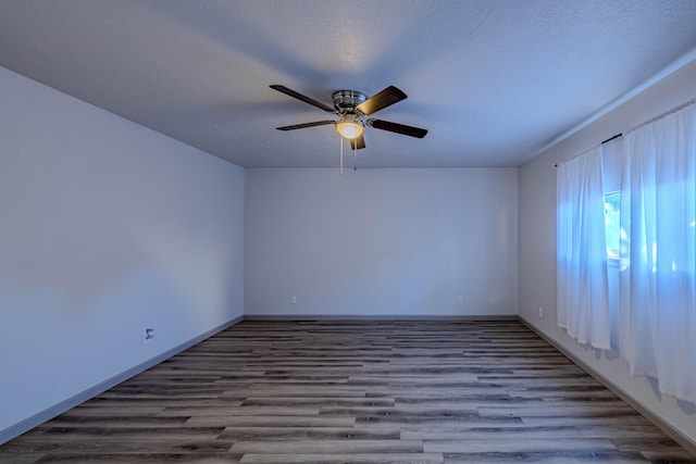 unfurnished room with ceiling fan, hardwood / wood-style flooring, and a textured ceiling