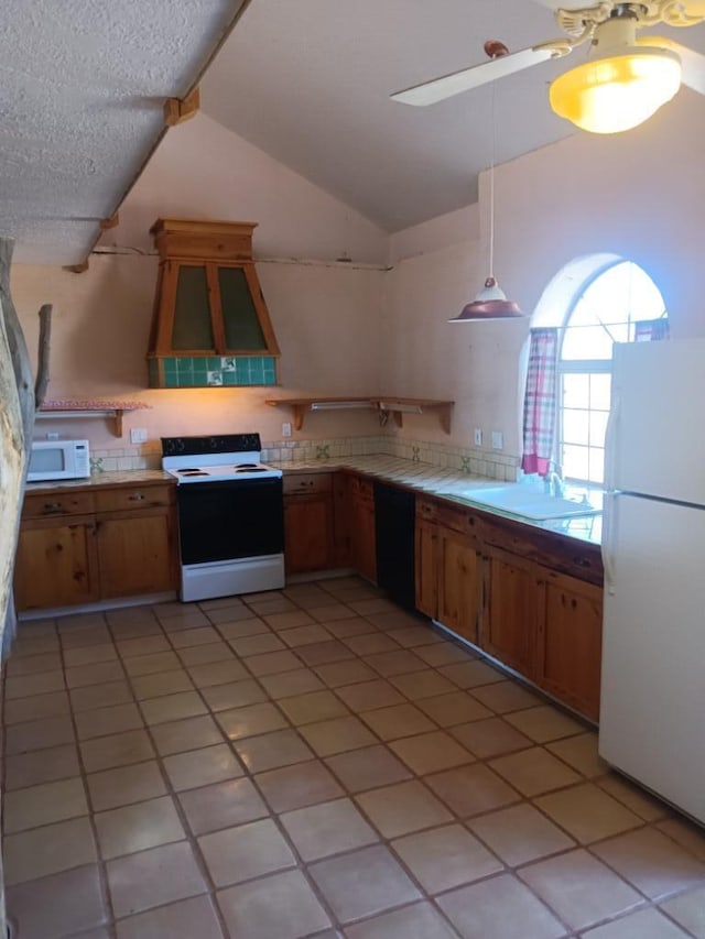 kitchen featuring ceiling fan, white appliances, lofted ceiling, tile countertops, and custom range hood