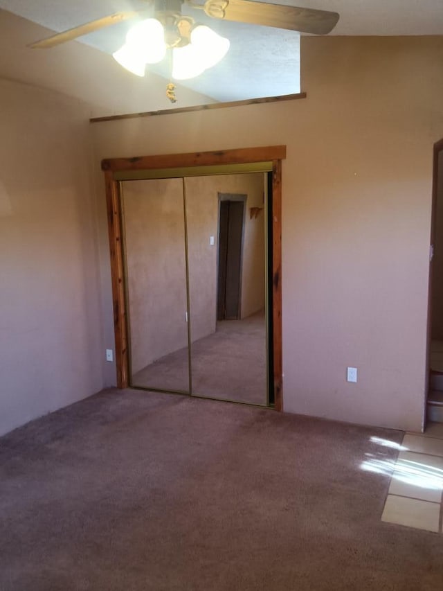 unfurnished bedroom with a closet, ceiling fan, and carpet floors