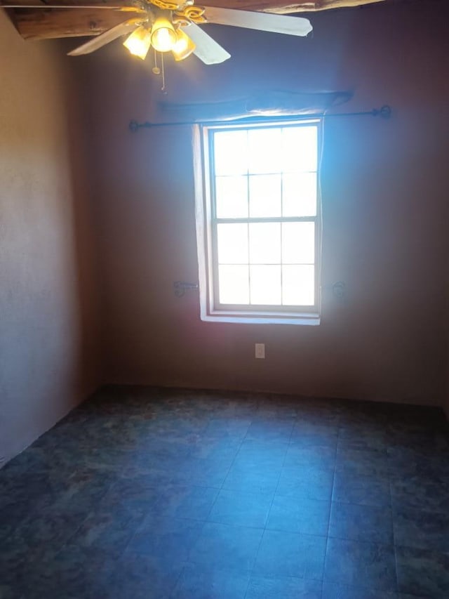 spare room featuring ceiling fan and tile floors