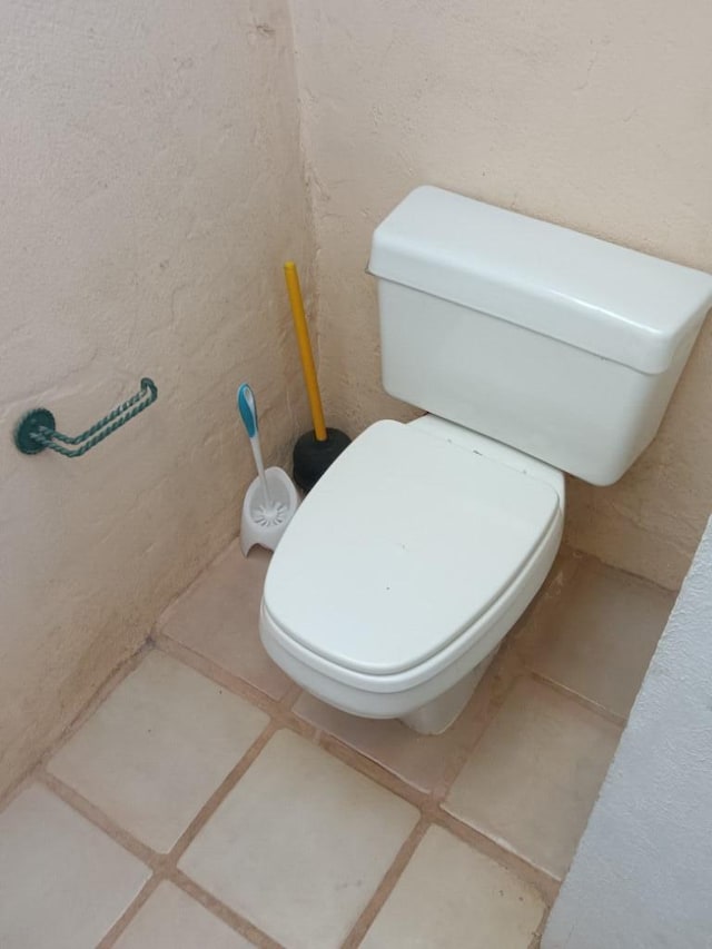 bathroom with tile floors and toilet