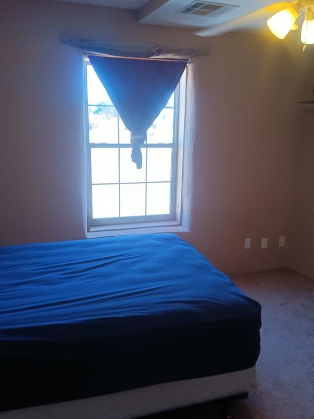 unfurnished bedroom with carpet and ceiling fan