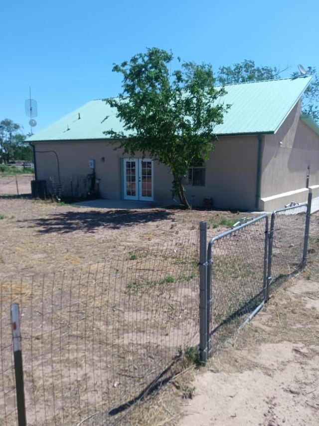 single story home with french doors and central AC unit