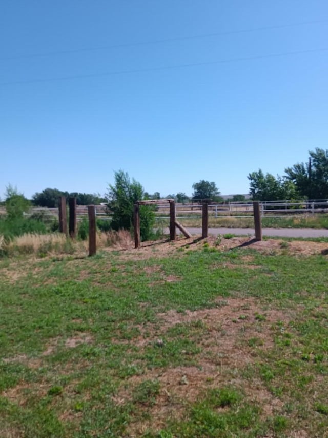 view of yard with a rural view