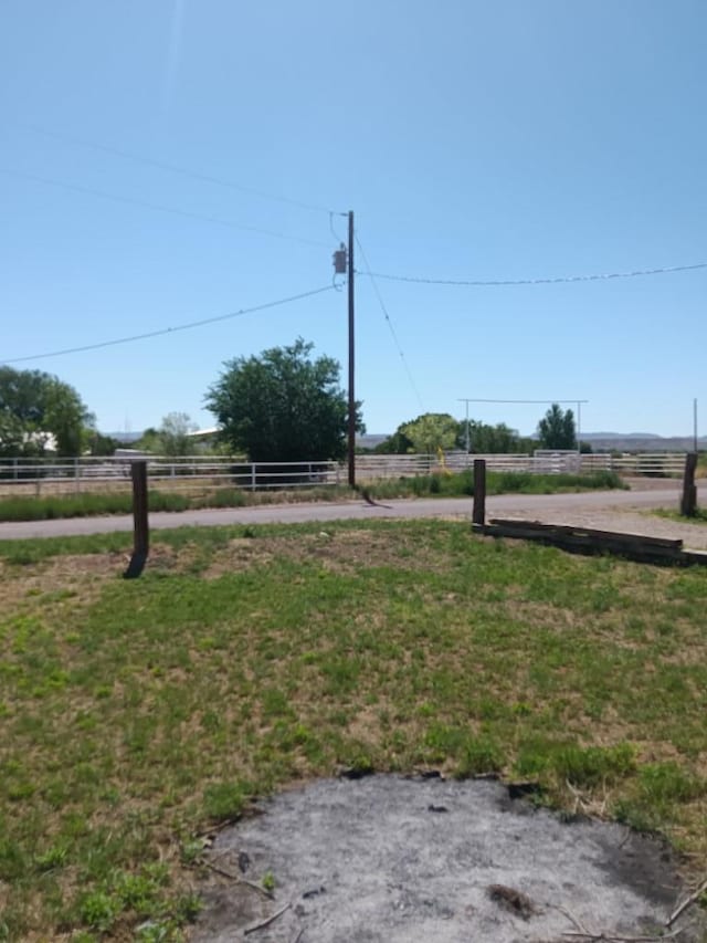 view of yard with a rural view