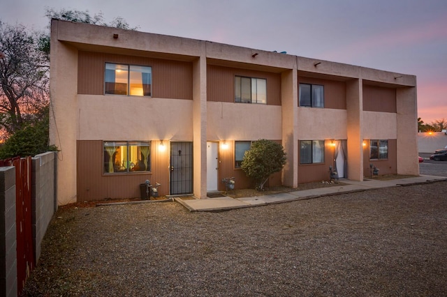 view of back house at dusk