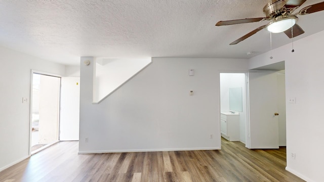 interior space featuring a textured ceiling, ceiling fan, and hardwood / wood-style flooring