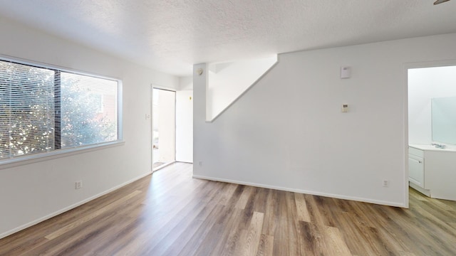 interior space featuring a textured ceiling and wood-type flooring