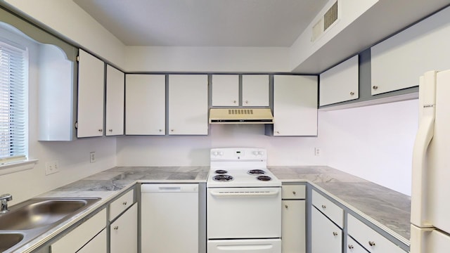 kitchen featuring sink, white appliances, and plenty of natural light