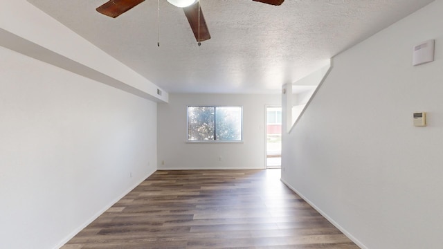 empty room featuring ceiling fan, hardwood / wood-style floors, and a textured ceiling