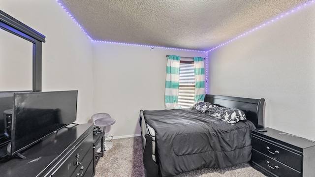 bedroom featuring a textured ceiling and carpet