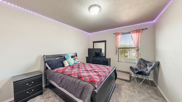 carpeted bedroom featuring a textured ceiling