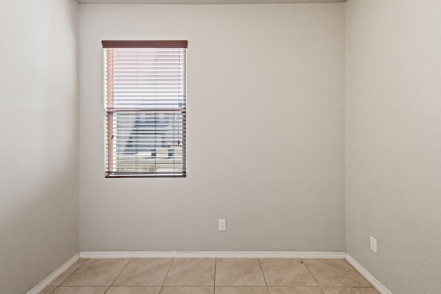 unfurnished room with light tile flooring