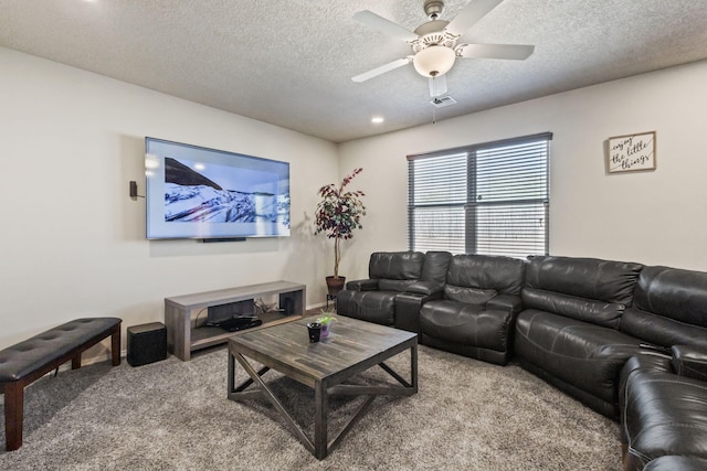 living room with carpet floors, ceiling fan, and a textured ceiling