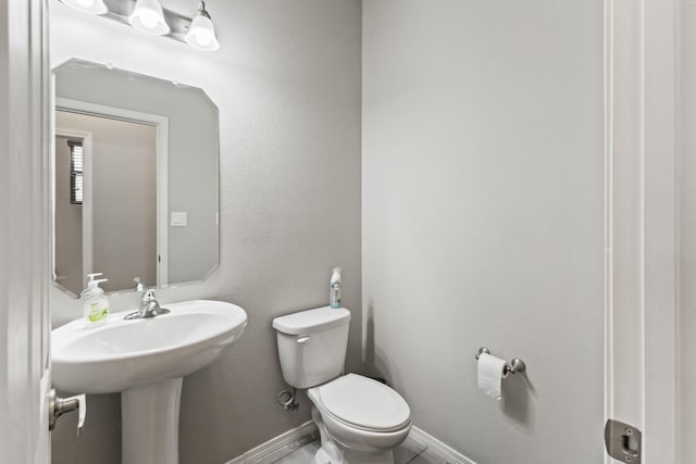 bathroom with tile floors and toilet