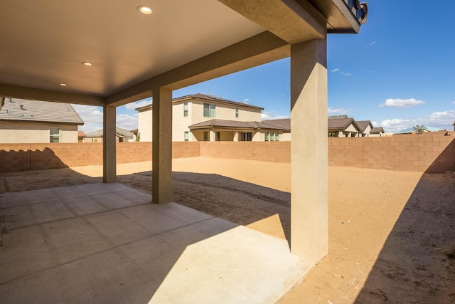 view of patio / terrace featuring a fenced backyard and a residential view