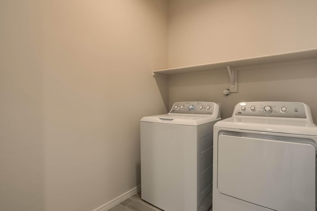 laundry area featuring washer and dryer, laundry area, and baseboards