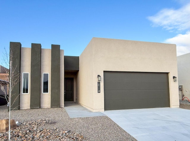 pueblo revival-style home featuring a garage