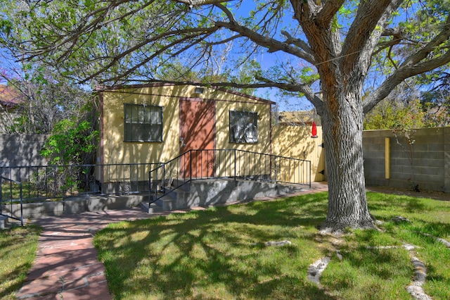 view of side of home with a lawn