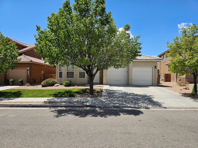 view of property hidden behind natural elements featuring a garage